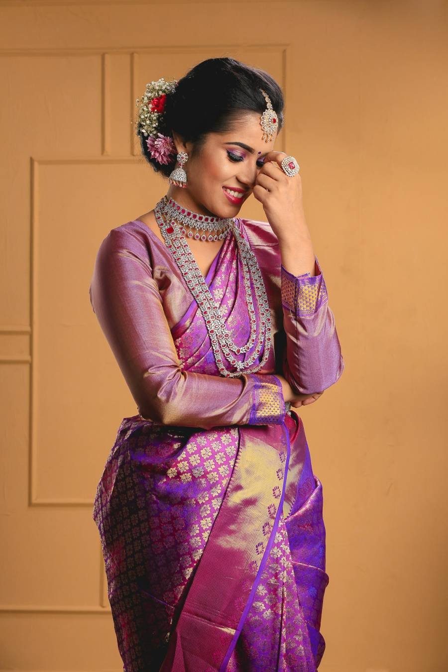 Woman in a purple and gold silk saree
