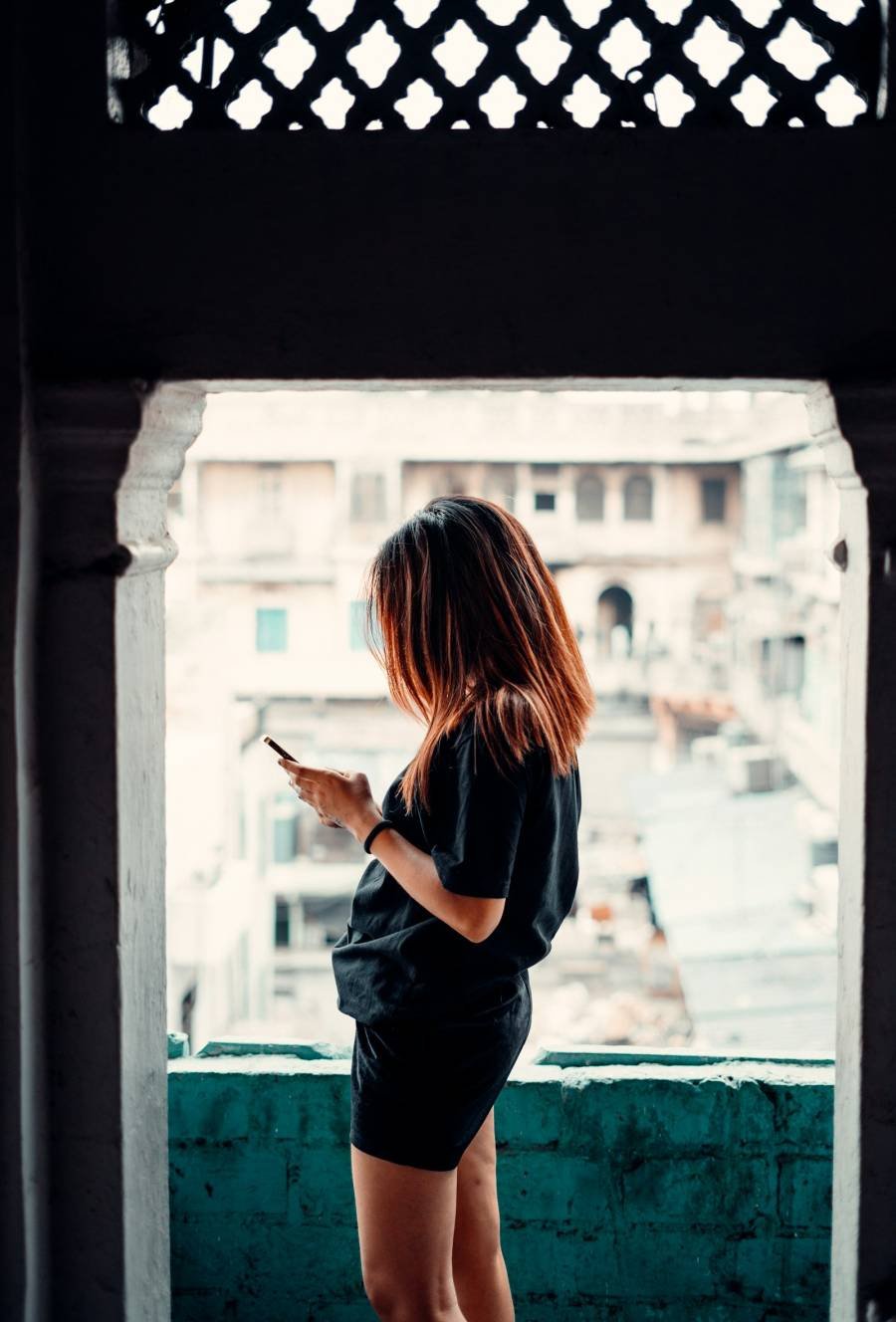Woman in a doorway looking at her phone